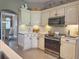 Modern kitchen features white cabinets, stainless appliances, and a tile backsplash at 2299 Twickingham Ct, Clermont, FL 34711