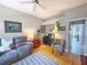 Cozy living room with comfortable seating, a ceiling fan, and a workspace with a desk at 2299 Twickingham Ct, Clermont, FL 34711
