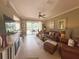 Inviting living room features tile floors, a ceiling fan, and sliding glass doors to the outdoor living space at 2299 Twickingham Ct, Clermont, FL 34711