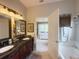 Luxurious bathroom featuring double sinks, granite countertops, and tub at 2299 Twickingham Ct, Clermont, FL 34711