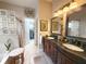 Bathroom boasting double vanities, walk-in closet, and glass block window at 2299 Twickingham Ct, Clermont, FL 34711