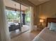 Bedroom with sliding glass doors leading to an outdoor entertainment area at 2299 Twickingham Ct, Clermont, FL 34711