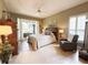 Cozy bedroom featuring a ceiling fan, sitting area, and tile flooring at 2299 Twickingham Ct, Clermont, FL 34711