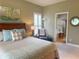 Relaxing bedroom featuring a comfortable chair and adjacent bathroom at 2299 Twickingham Ct, Clermont, FL 34711