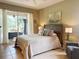 Comfortable bedroom with a queen bed and sliding door to the outdoor space at 2299 Twickingham Ct, Clermont, FL 34711