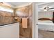 Tiled shower with a window and partial view of the bedroom at 26653 Otter Creek Ln, Leesburg, FL 34748