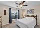 Cozy bedroom with natural light, a ceiling fan, and dark curtains and furniture at 26653 Otter Creek Ln, Leesburg, FL 34748
