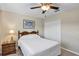 Bedroom featuring a window, neutral walls, dark curtains, and a closet at 26653 Otter Creek Ln, Leesburg, FL 34748