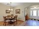 Inviting dining area with wood floors and elegant chandelier, adjacent to the foyer at 26653 Otter Creek Ln, Leesburg, FL 34748