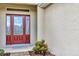 Up close view of a beautiful red front door framed with glass and sidelights at 26653 Otter Creek Ln, Leesburg, FL 34748