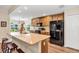 Modern kitchen featuring stainless steel appliances, a spacious island, and ample cabinet space at 26653 Otter Creek Ln, Leesburg, FL 34748