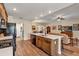 Modern kitchen featuring a center island with a sink, wood cabinets and countertops with an open floor plan at 26653 Otter Creek Ln, Leesburg, FL 34748