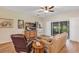 Cozy living room with comfortable seating and sliding glass doors to outdoor space at 26653 Otter Creek Ln, Leesburg, FL 34748