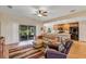Open-concept living space with sliding glass doors, seamlessly connecting to the kitchen at 26653 Otter Creek Ln, Leesburg, FL 34748
