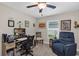 This well-lit office space features a comfortable blue recliner, ceiling fan, and functional desk at 26653 Otter Creek Ln, Leesburg, FL 34748