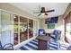 Enjoy this cozy patio with a ceiling fan, outdoor rug, and comfortable wicker seating at 26653 Otter Creek Ln, Leesburg, FL 34748