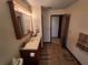 Bright bathroom with a wooden vanity, a large mirror, and updated fixtures at 29205 Old E Ml, Tavares, FL 32778