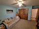 Relaxing bedroom with comfortable sofa, ceiling fan, and closet offering ample storage space at 29205 Old E Ml, Tavares, FL 32778