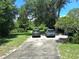 Long driveway leading to a property with ample parking and lush, mature trees surrounding it at 29205 Old E Ml, Tavares, FL 32778