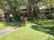 Charming single-story home featuring lush landscaping, a stone pathway, and a well-manicured lawn at 29205 Old E Ml, Tavares, FL 32778
