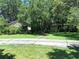 Beautiful home featuring mature landscaping, a mix of stone and siding, and a long driveway at 29205 Old E Ml, Tavares, FL 32778