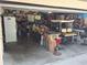 Cluttered two car garage used for storage, with a golf cart and assorted household items and shelving at 29205 Old E Ml, Tavares, FL 32778