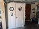 A closet inside the garage to store additional items, decorated with a snake sticker and a feather art piece at 29205 Old E Ml, Tavares, FL 32778