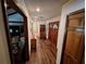 Inviting hallway with wood floors, a wood door, and decorative cabinets for added charm at 29205 Old E Ml, Tavares, FL 32778