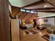 Spacious living room featuring vaulted ceilings, exposed beams, and wood paneled accent wall at 29205 Old E Ml, Tavares, FL 32778