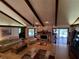 Open living room with exposed beams and a stone fireplace, perfect for entertaining and relaxation at 29205 Old E Ml, Tavares, FL 32778