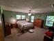 Large main bedroom with three windows, ceiling fan, and light hardwood furniture at 29205 Old E Ml, Tavares, FL 32778