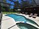 This in-ground pool and spa features ample seating, and screened enclosure at 29205 Old E Ml, Tavares, FL 32778