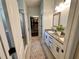 Bathroom featuring double sinks, granite countertop, and shower with glass door at 295 Whirlaway Drive, Davenport, FL 33837