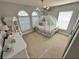 Bedroom featuring a uniquely styled princess carriage bed, chandelier, and bright natural lighting at 295 Whirlaway Drive, Davenport, FL 33837