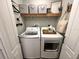 Convenient laundry room with modern washer and dryer, complemented by ample storage and stylish accents at 295 Whirlaway Drive, Davenport, FL 33837