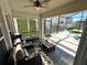 Relaxing screened patio with comfortable seating and ceiling fan overlooking the backyard at 295 Whirlaway Drive, Davenport, FL 33837