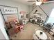 Spacious playroom with imaginative play areas including market, kitchen, and dining space for children at 295 Whirlaway Drive, Davenport, FL 33837