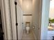 Powder room with a toilet and patterned wallpaper at 295 Whirlaway Drive, Davenport, FL 33837