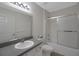 Neutral bathroom featuring a shower and tub combo and a granite topped vanity at 32942 Rambling Oaks Ct, Leesburg, FL 34748