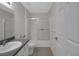Clean bathroom features a shower-tub combo and a neutral color scheme at 32942 Rambling Oaks Ct, Leesburg, FL 34748