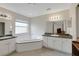 Bright bathroom features a garden tub with dual vanities, providing ample space and natural light at 32942 Rambling Oaks Ct, Leesburg, FL 34748