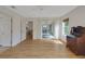 Bedroom featuring hardwood floors, slider doors and natural light in a clean and spacious setting at 32942 Rambling Oaks Ct, Leesburg, FL 34748