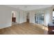 Bright bedroom with hardwood floors, slider doors to a patio, a ceiling fan, and natural light at 32942 Rambling Oaks Ct, Leesburg, FL 34748