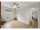 Simple bedroom features laminate wood flooring, ceiling fan, and a window at 32942 Rambling Oaks Ct, Leesburg, FL 34748