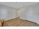 Bedroom with wood flooring, double closets, and white walls at 32942 Rambling Oaks Ct, Leesburg, FL 34748