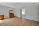 The bedroom has wood-look floors, a ceiling fan, and a bright and open feel at 32942 Rambling Oaks Ct, Leesburg, FL 34748
