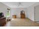 Spacious bedroom with wood-look flooring, ceiling fan, and bright natural light at 32942 Rambling Oaks Ct, Leesburg, FL 34748
