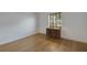 Bedroom with a hardwood floor, a window with blinds, and a desk in front of the window at 32942 Rambling Oaks Ct, Leesburg, FL 34748