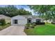 Charming single-story home with a well-maintained lawn and landscaped garden at 32942 Rambling Oaks Ct, Leesburg, FL 34748