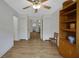 Hallway leading to other rooms, featuring laminate wood flooring and neutral paint at 32942 Rambling Oaks Ct, Leesburg, FL 34748